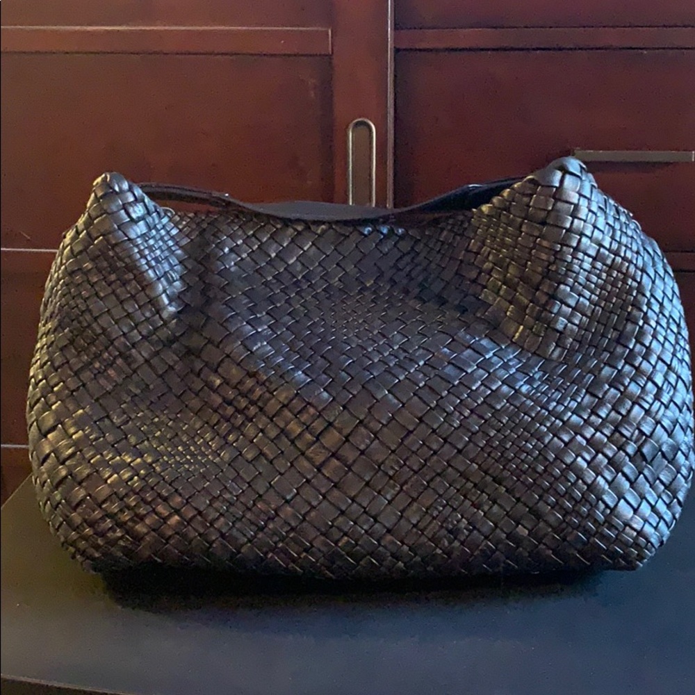 Black woven leather satchel handbag.